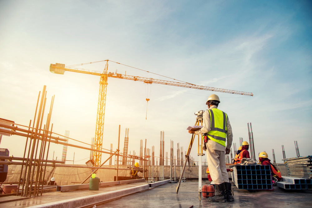 contractor at contruction site with crane