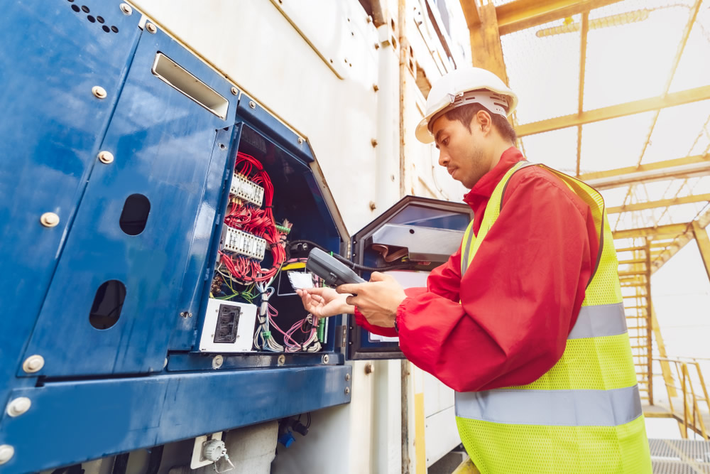 electrician working at industrial panel