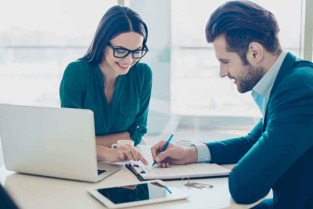 Entrepreneurs reviewing application man and woman reviewing application documents