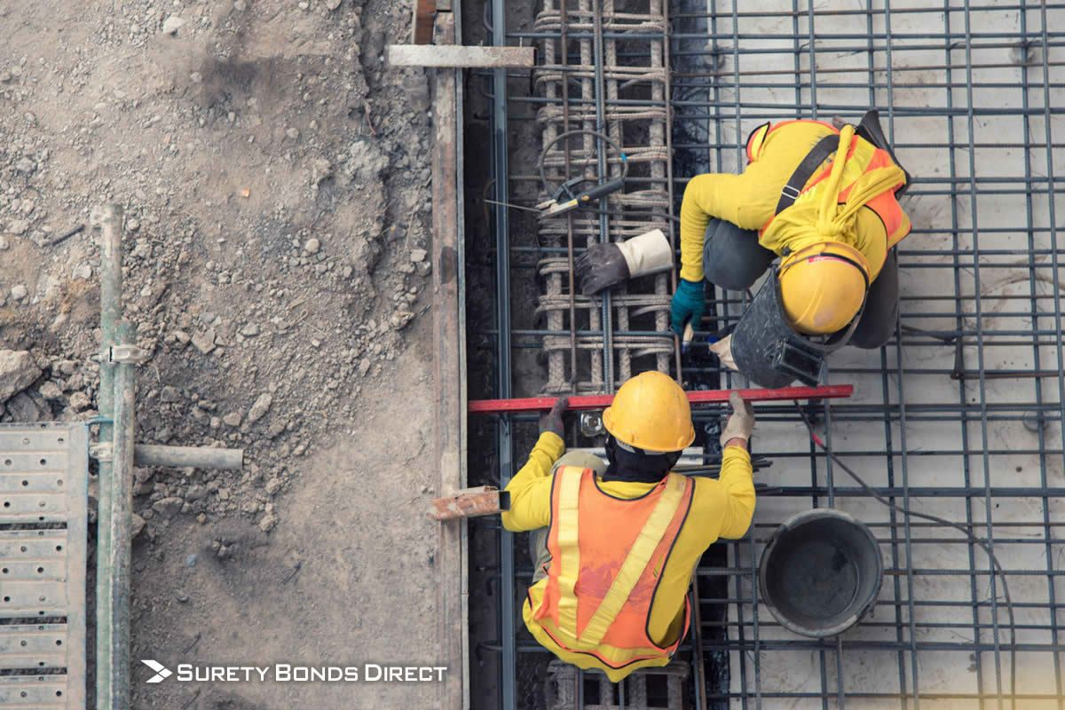 Contractors working on rebar at construction site