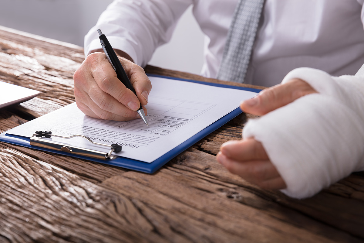 injured man signing documents