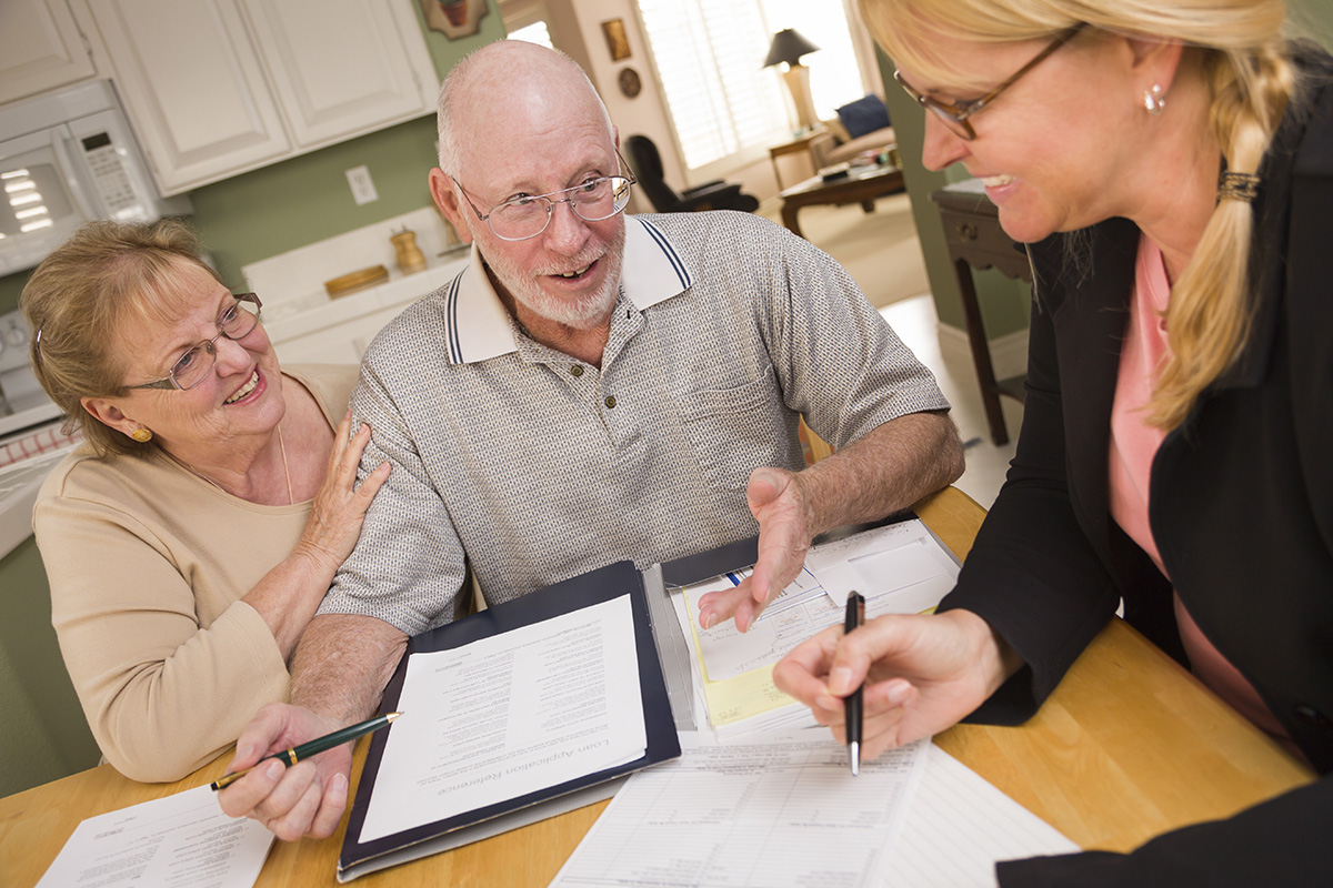 Tax preparer working with clients in their kitchen