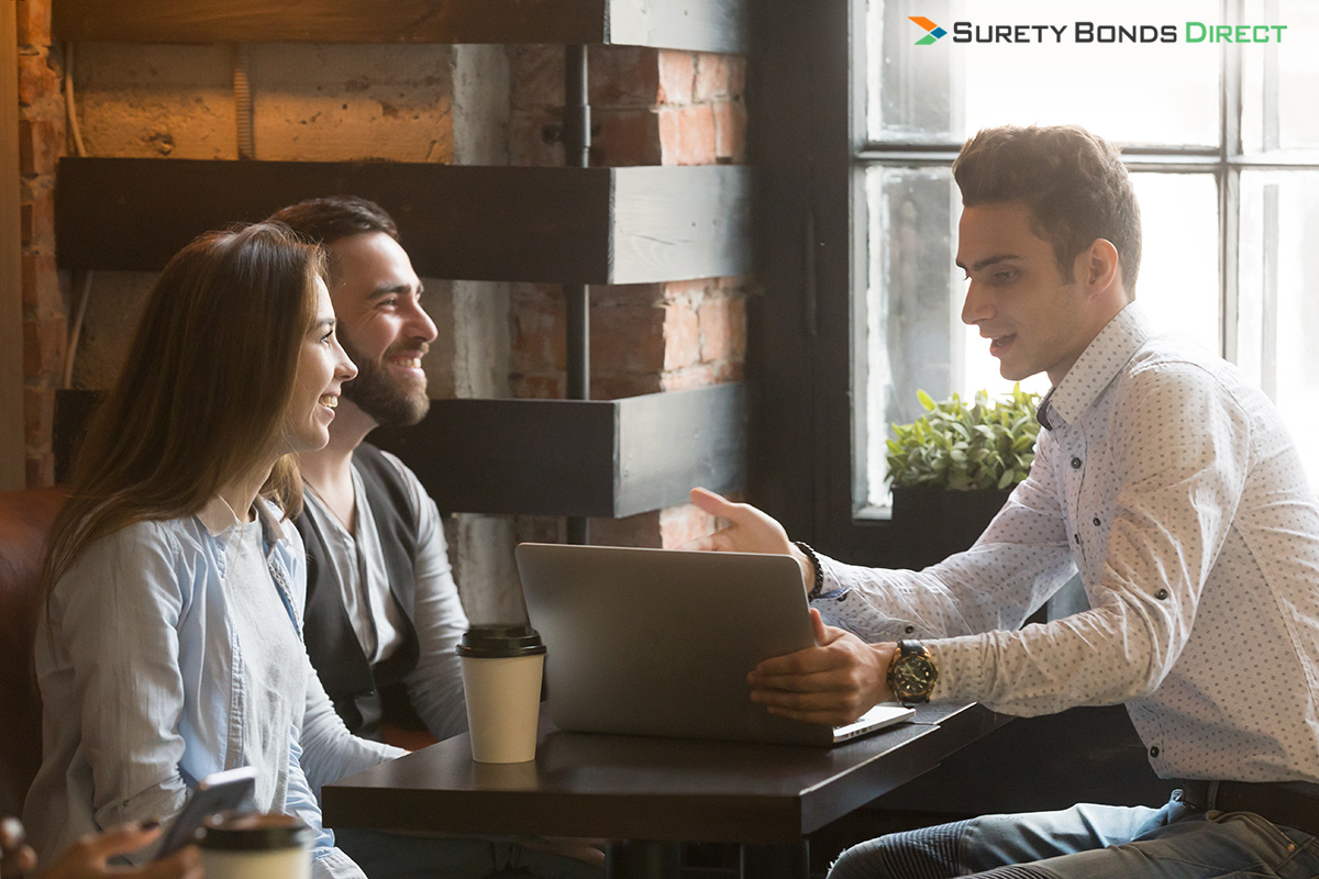 couple sitting with a mortgage broker