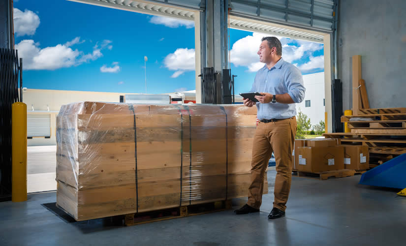 Man at loading dock waiting for pickup of a pallet