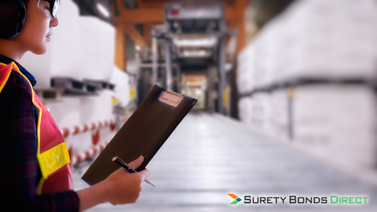 Supervisor with clipboard in a shipping warehouse