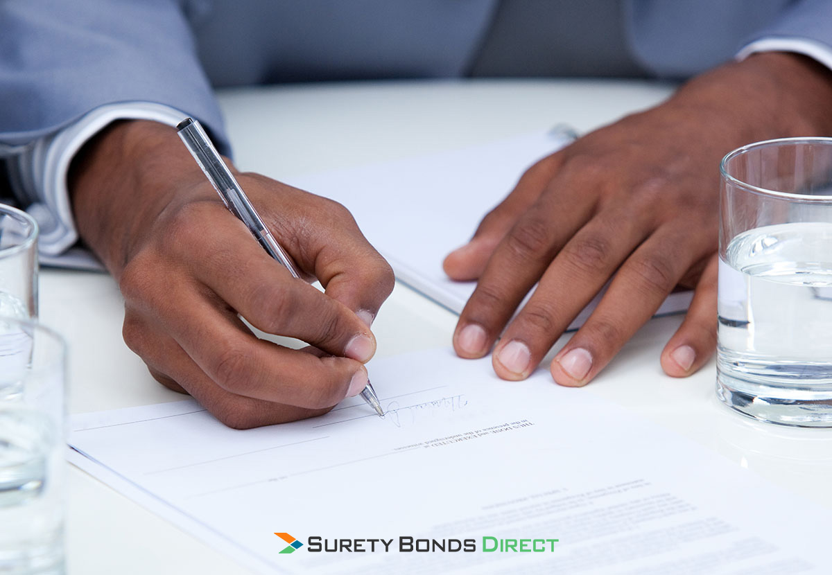 man signing surety bond